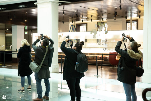 Photography students capturing architectural features during indoor workshop session in Sydney