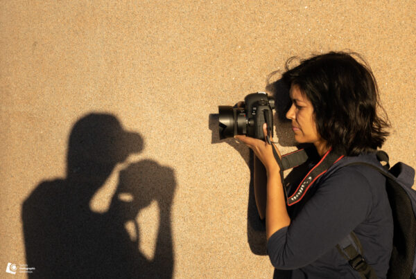 Photography student using afternoon shadows for creative shot during Sydney workshop
