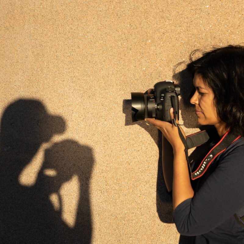 Photography student using afternoon shadows for creative shot during Sydney workshop