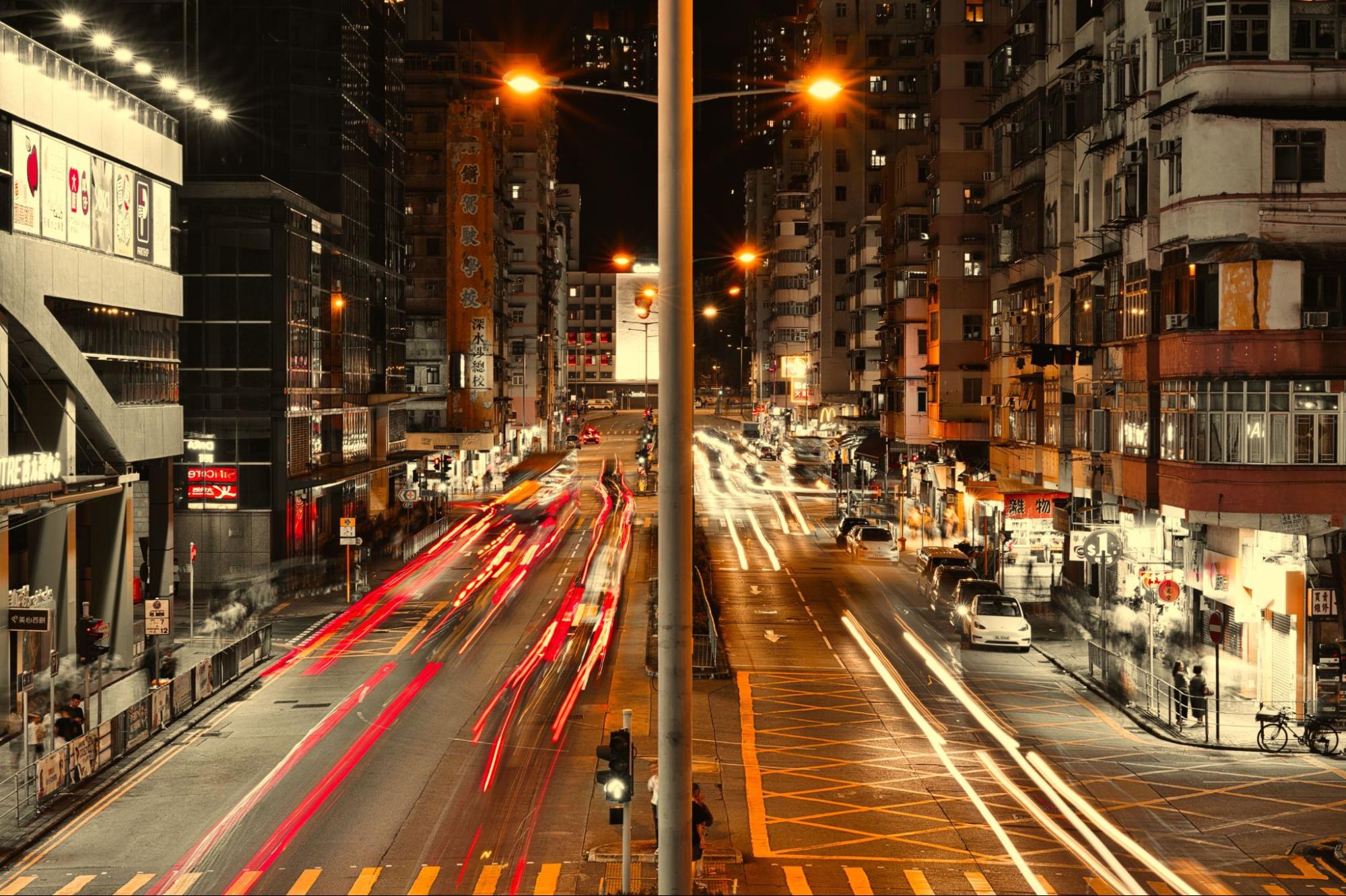 City street at night with traffic light trails from a long exposure