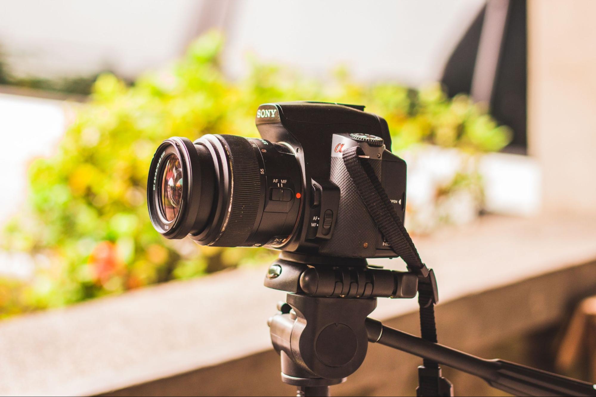Digital camera mounted on a tripod outdoors